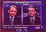 A still from a CNN broadcast of two reporters talking to each other.