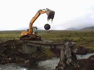 An image of a construction site with a moving excavator.