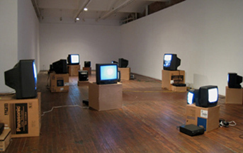 A view of a bunch of Box TV's set up in different positions in a room.