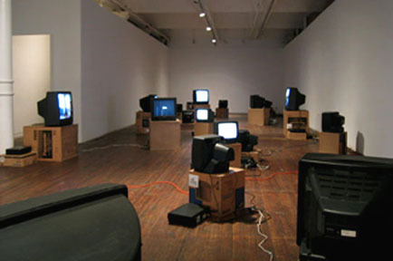 A room with a bunch of Box TV's in various positions.