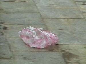 A still of a video of a pink plastic bag on concrete.