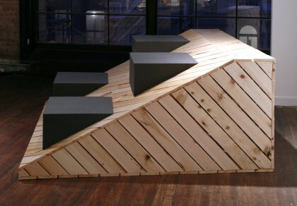 A slanted wood object, with gray squares poking out.
