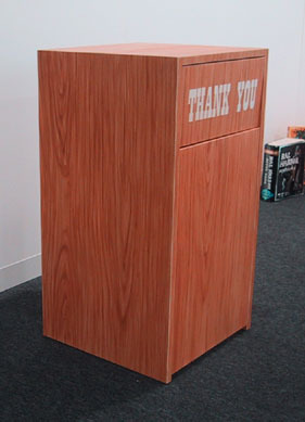A wooden box with "Thank You" painted on the front slot.