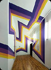An image of a hallway with purple and yellow lines going along the walls and ceiling.