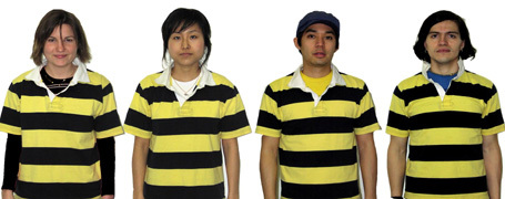 Four people wearing yellow and black striped t-shirts in a row.