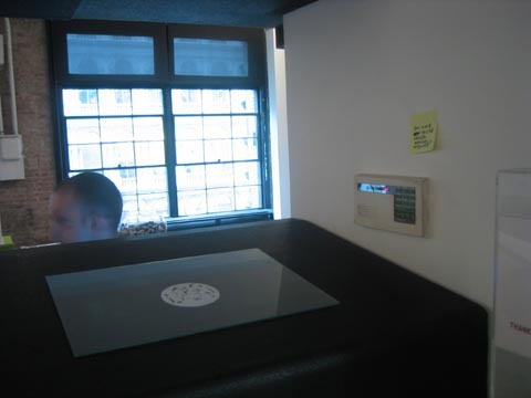 A big box with a person sitting behind it.
