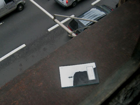 A book sitting on the ledge of a rooftop.