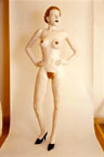 A female mannequin looking to the right with her hands on her waist.