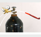 A close-up shot of a tank with pipes coming from it.