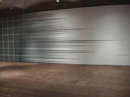 A white wall with black striped moving horizontally.