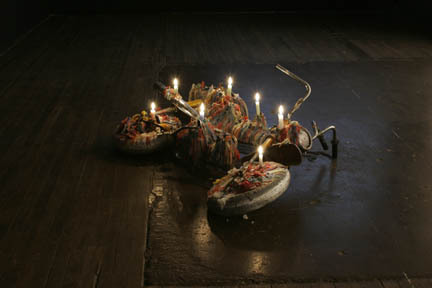 A sculptural work of a bike with lights on the floor.