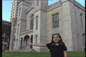 A young girl standing in front of a big castle, with her hand stretching out towards the entrance.