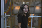 A child mid-movement turning back towards the camera.