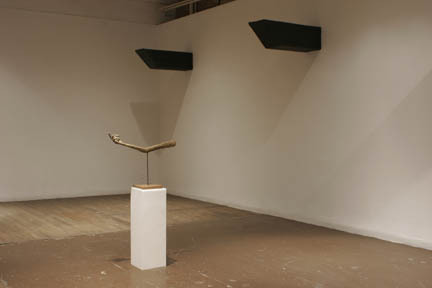 A sculpture hand in the middle of a large gallery space.