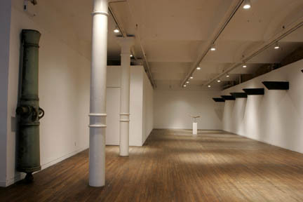 A zoomed out view of the gallery with sculptures around the space.